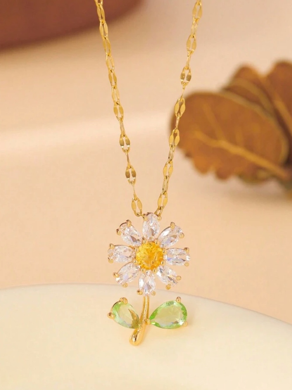 Gold Daisy Pendant Necklace with Yellow Center and Green Leaves